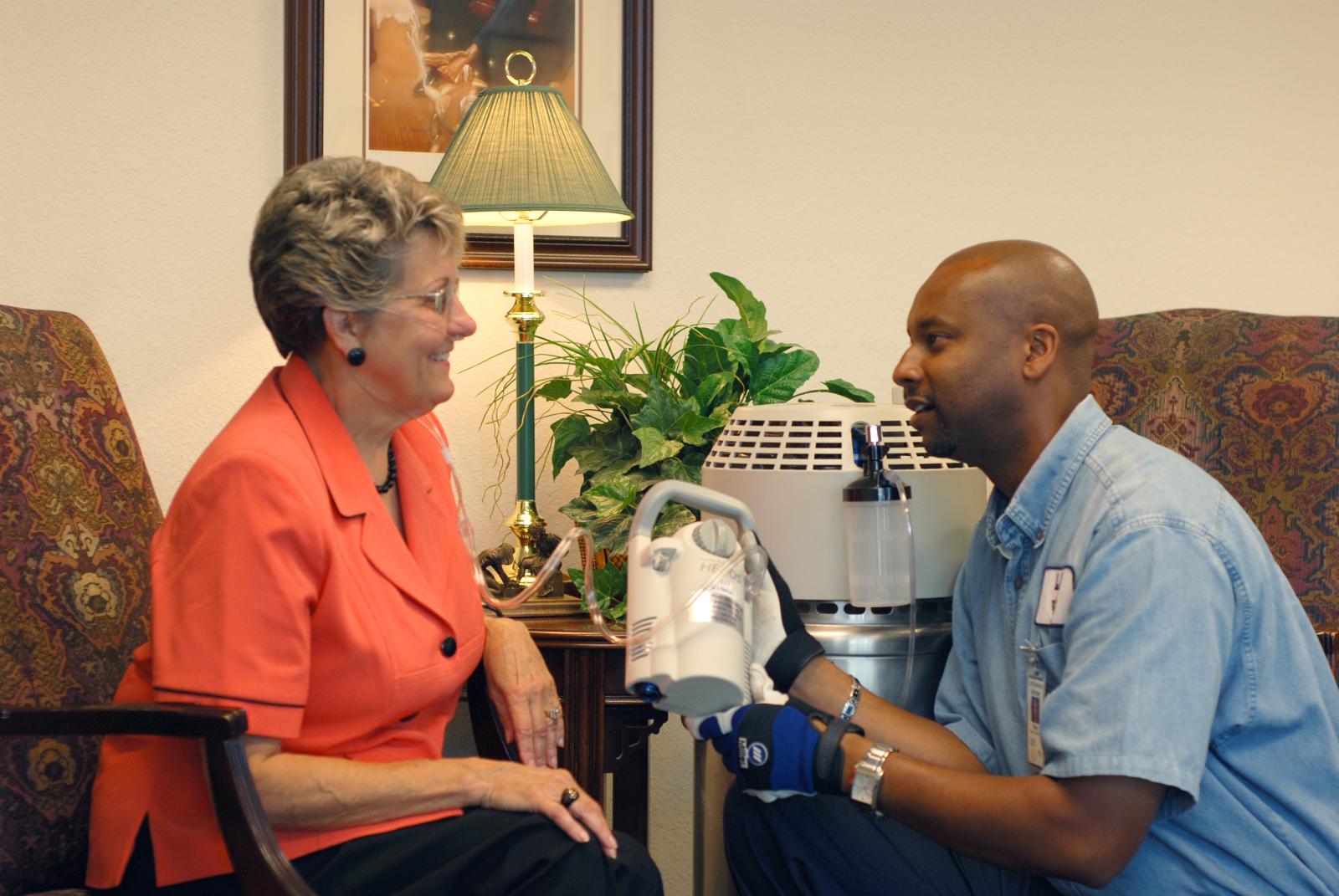 tech helping elderly woman with ventilator